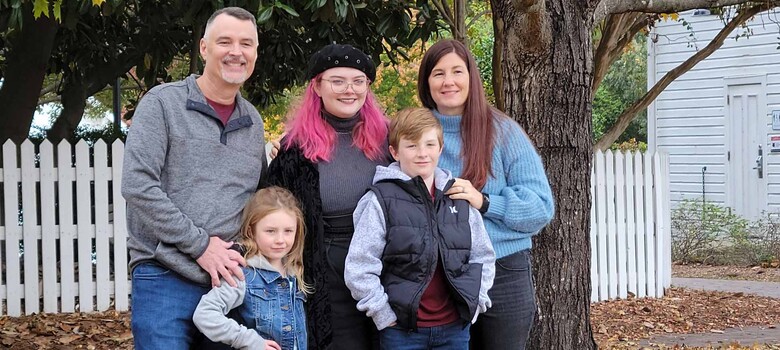 David Wilkie and family smile outside